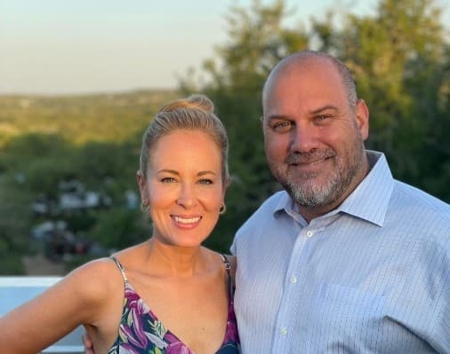Dr. Hogan standing with husband during sunset.