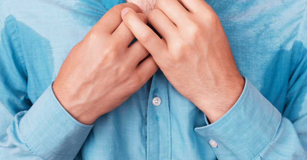 Close-up of a candidate for miraDry, who has sweat through his shirt.