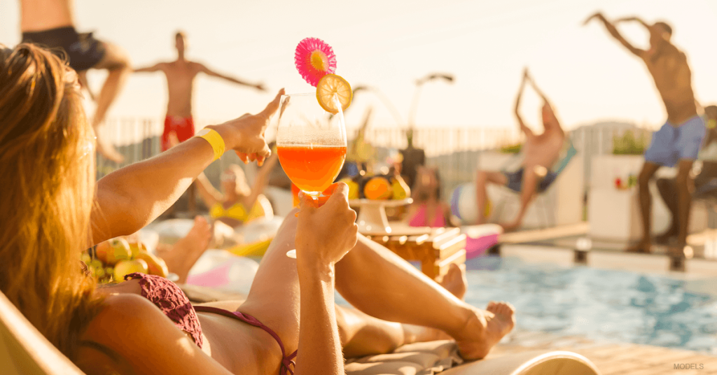 People relax by the pool on a warn day.