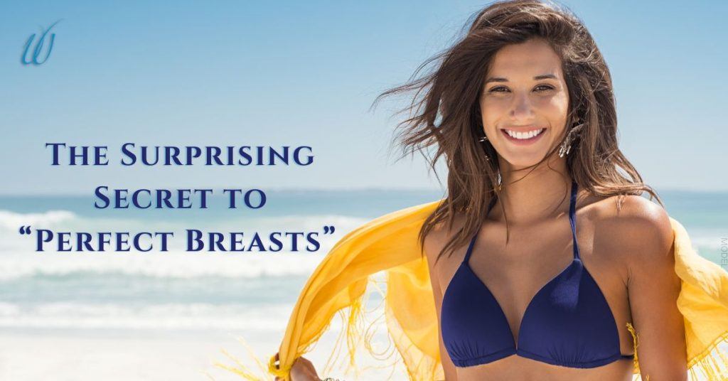 woman smiling on the beach in a blue bathing suit and yellow scarf