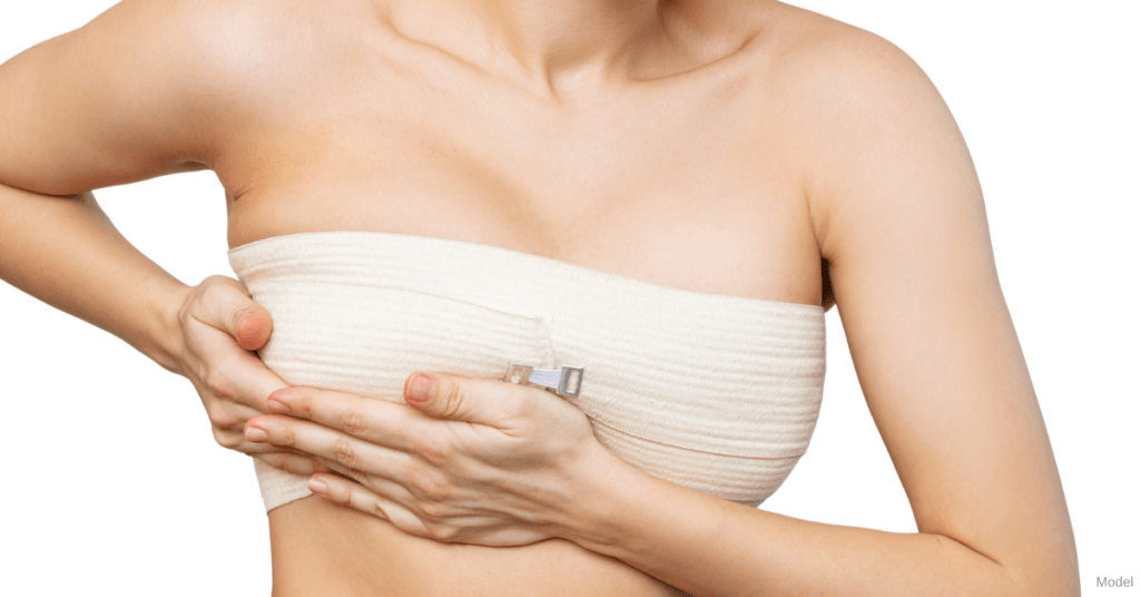 Woman wearing a recovery wrap after breast surgery (model)