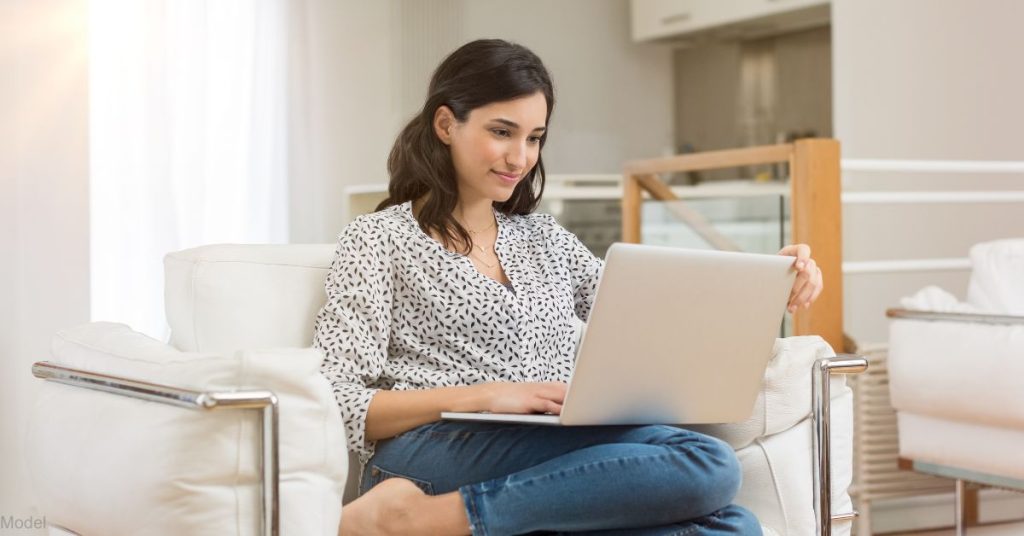 A woman researching on her laptop (model)